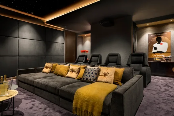 Private home cinema with tiered seating, star ceiling and immersive audio